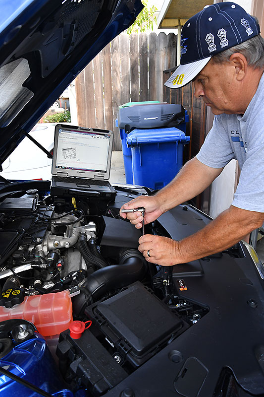 The reviewer has just begun the work necessary to change a set of spark plugs in the 3.6L engine in an ATS-V. GMSi on the display of the laptop in the background using a Wi-Fi connection. Image: Author.