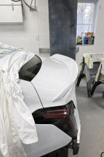 White Cadillac in garage setting.png